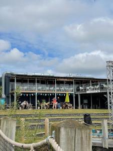 a large building with people sitting outside of it at Sunscape breaks At Tattershall Lakes in Tattershall