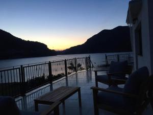 a balcony with chairs and a view of the water at VILA SARA in Vârtopu