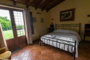 a bedroom with a bed and a large window at Agriturismo il Poggio in Vetralla