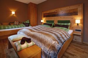 a bedroom with a large bed with shoes on it at Apartments am alten Rathaus in Oberstdorf