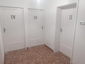 a room with three white doors and a tile floor at CASA DELLE GUARDIE b&b in Madonna di Fornelli