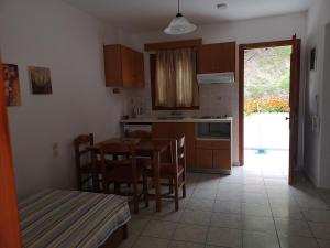 a kitchen with a table and chairs and a dining room at Drosia apartments in Skiathos