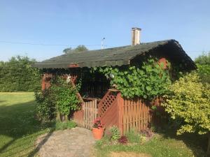 a small house with a black roof at Bokaczówka in Ustka +6 photos