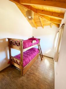 a room with two bunk beds in a attic at Hermoso departamento con vista al cerro catedral! in San Carlos de Bariloche