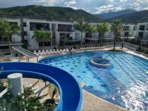 a swimming pool at a hotel with a resort at Apartasol Santafe de Antioquia 15 in Santa Fe de Antioquia