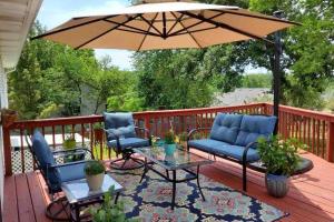 a patio with two chairs and an umbrella on a deck at Smart Entire Loft, 3 br, 2 bath, with 3 tv in Columbia