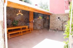 a patio with a wooden bench and a building at SEIA Alojamento D Ines in Seia