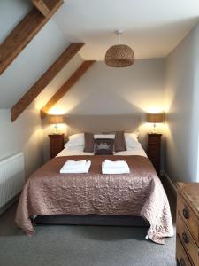 a bedroom with a bed with two towels on it at Selkies NQY in Newquay