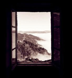 a window with a view of a mountain and water at Albergue ESCANLAR in Lugo