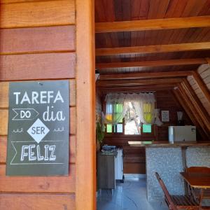 a restaurant with a sign on the side of a wall at CHALÉ HAKUNA MATATA-Vale do capão in Vale do Capao