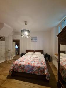 a bedroom with a bed and a chandelier at Château des Bosquets in Étretat