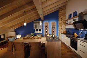 a kitchen with blue walls and a table with chairs at Apartments am alten Rathaus in Oberstdorf