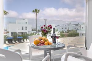 a plate of fruit on a table on a balcony at Bellini Hotel in Ayia Napa