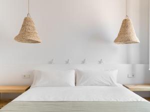 A bed or beds in a room at S'Enclova Petit Hotel