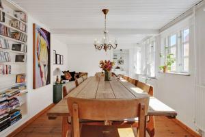 uma sala de jantar com uma mesa de madeira e cadeiras em Hyggeligt gammelt fiskerhus i Marstal em Marstal