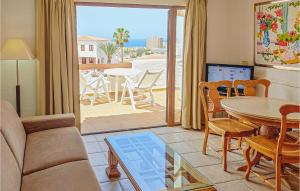 a living room with a couch and a table at Stunning Apartment In Los Cristianos With House Sea View in Los Cristianos