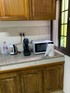 a kitchen counter with a toaster and a microwave at Appartement chic et moderne in Douala