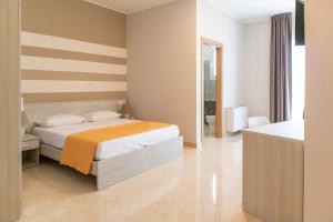 Un pat sau paturi într-o cameră la Karpignàna Hotel