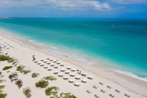 an aerial view of a beach with chairs and umbrellas at TRS Coral Hotel - Adults Only - All Inclusive in Cancún