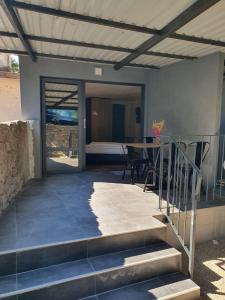a patio with a table and chairs in a house at MIAU Premium apartments in Selce