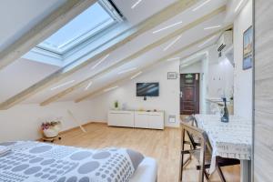 a bedroom with a bed and a table and a tv at Apartment light in Pula in Pula