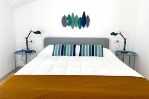 a bedroom with a large bed with two lamps at Terrazza Vista Mare in Borgio Verezzi