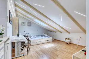 a room with a desk and a table in a attic at Apartment light in Pula in Pula