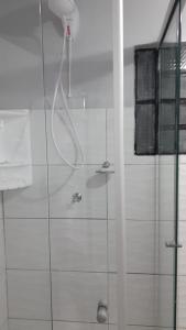 a bathroom with a shower with a glass door at Casa Grey in Cambara do Sul