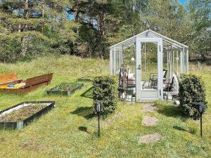 a greenhouse in a field with some plants in it at 6 person holiday home in L derup in Löderup