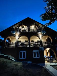 a black building with balconies and lights on it at Apartmani Vera in Vinci