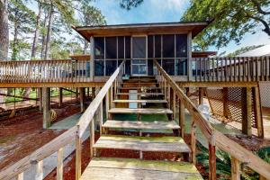 a large house with stairs leading up to it at Coronado Cove Cottage in Dauphin Island