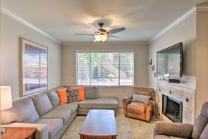 a living room with a couch and a fireplace at Scottsdale Condo with Pool Walk to Kierland Resort in Scottsdale