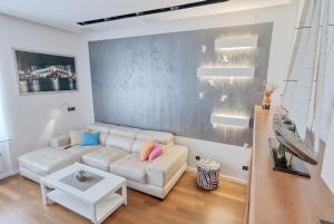 a living room with a couch and a table at Apartment light in Pula in Pula