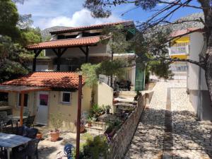 a house with a table and a fence at Apartments Dunja Hvar in Ivan Dolac