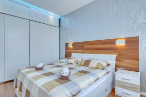 a bedroom with a bed with two shoes on it at Apartment light in Pula in Pula
