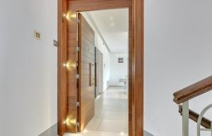 a hallway with a wooden door with a mirror at Apartment light in Pula in Pula