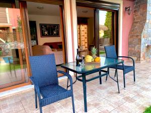 a glass table and chairs on a patio at Villa Katerina in Stalida