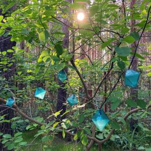 a tree with blue birdhouses hanging from it at Vila Dunavski Raj in Golubac