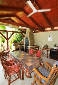 a patio with a table and chairs and a stone fireplace at Šumski raj in Subotica