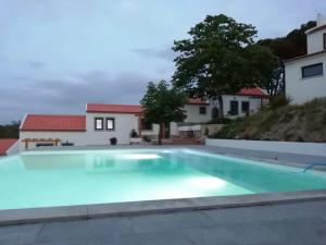 a large swimming pool in the backyard of a house at Villa Vista in Sesimbra