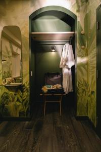a dressing room with a suitcase and a mirror at Ode in Toronto