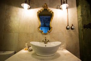 a bathroom with a sink and a mirror on the wall at Vila Terrasse in Košice