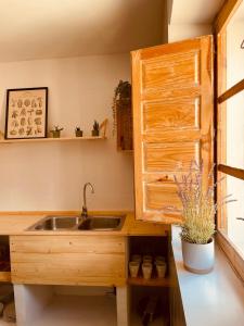 a kitchen with a sink and a wooden cabinet at El desván de Bruno in Villalobos