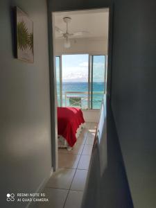a room with a window with a view of the ocean at Casa NA PRAIA do Peró in Cabo Frio