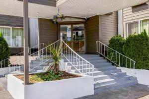 a house with stairs leading to the front door at Studio 6-Portland, OR in Parkrose