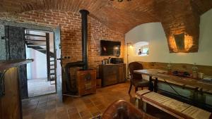 a living room with a brick wall and a table at Apartmány Na Návsi 19 u Hluboké in Hrdějovice