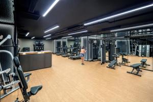 a woman in a gym with several machines at PARKROYAL COLLECTION Marina Bay, Singapore in Singapore