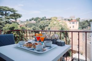 a tray of breakfast food on a table on a balcony at La collina di Capodimonte in Naples