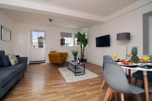 a living room with a couch and a table at St Thomas Loft Views by Stay South Wales in Swansea