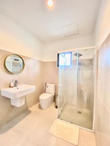 a bathroom with a shower and a sink and a toilet at Elaine's Homestay in Dumaguete